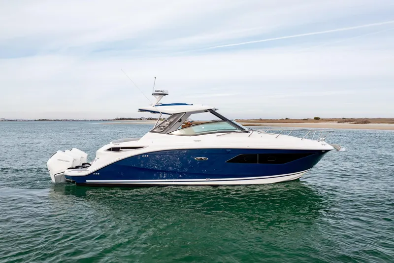 Slide: The Image of 2020 Sea Ray Sundancer 320 Outboard cruising on open water. - 9
