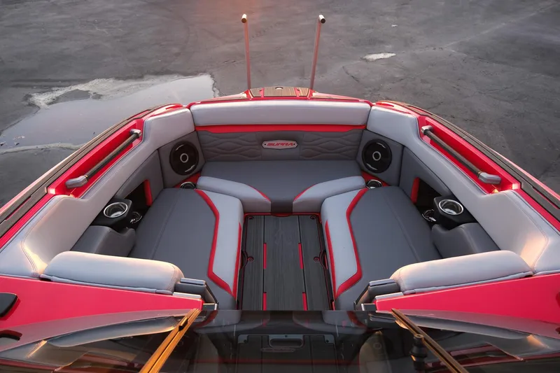 Slide: The Image of 2025 Supra SE boat interior with red and gray seating, cup holders, and speakers. - 12