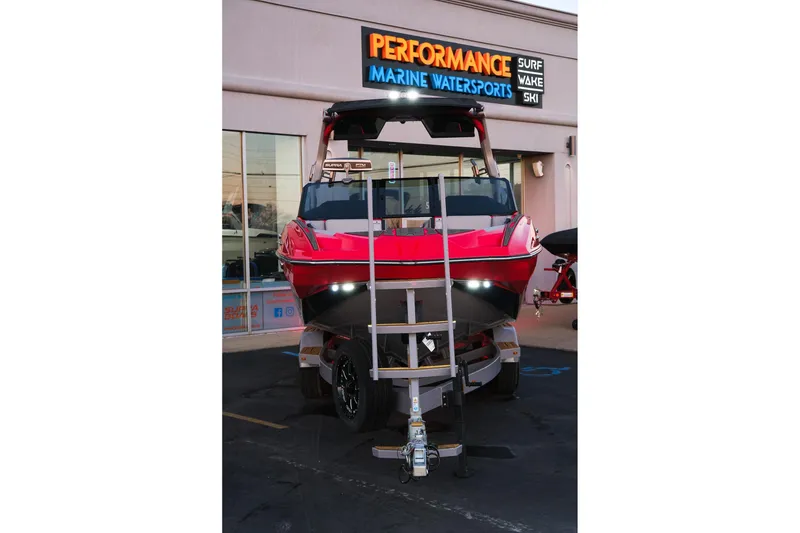 Slide: The Image of 2025 Supra SE boat in front of Performance Marine Watersports store. - 13