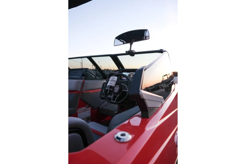 Slide: The Image of 2025 Supra SE boat interior with steering wheel and dashboard at sunset. - 16