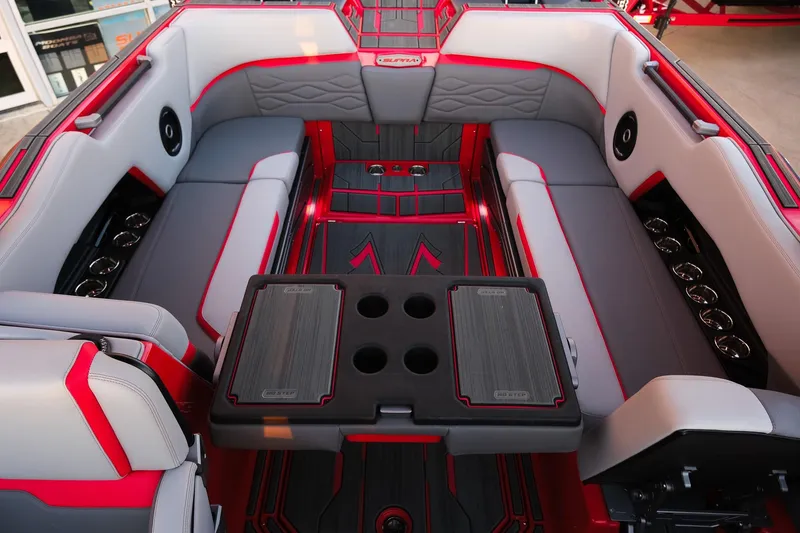 Slide: The Image of 2025 Supra SE boat interior with red and gray seating, cup holders, and stylish design. - 17