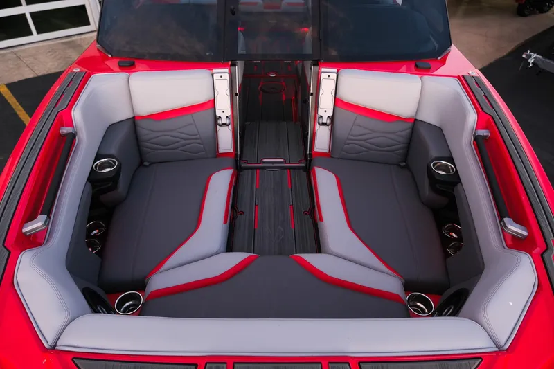 Slide: The Image of 2025 Supra SE interior with red and gray seating, cup holders, and modern design. - 25