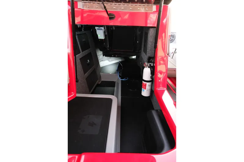 Slide: The Image of Interior of 2025 Supra SE vehicle, featuring storage compartments and a fire extinguisher. - 27