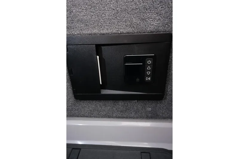 Slide: The Image of 2025 Supra SE interior control panel with buttons on a textured surface. - 28