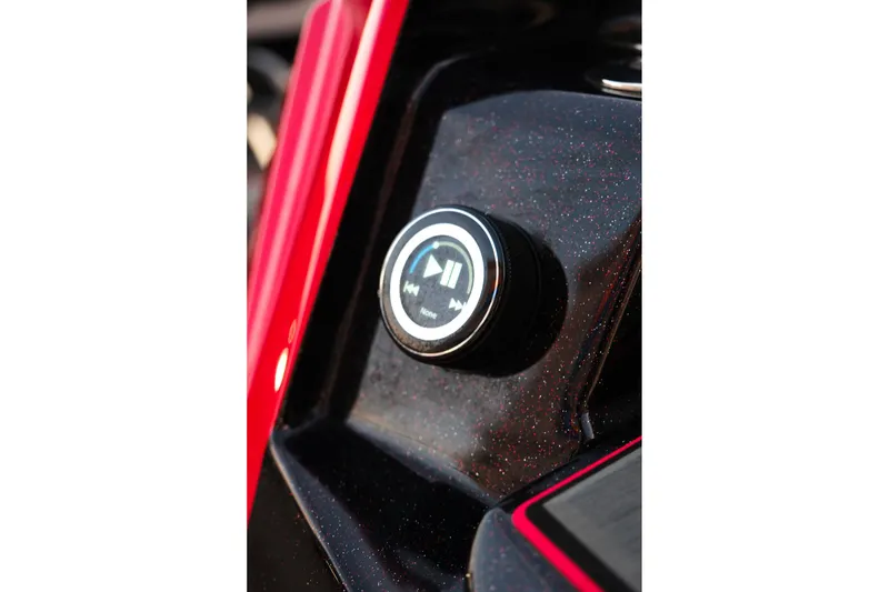 Slide: The Image of 2025 Supra SE dashboard with multimedia control knob, featuring play and pause icons. - 31