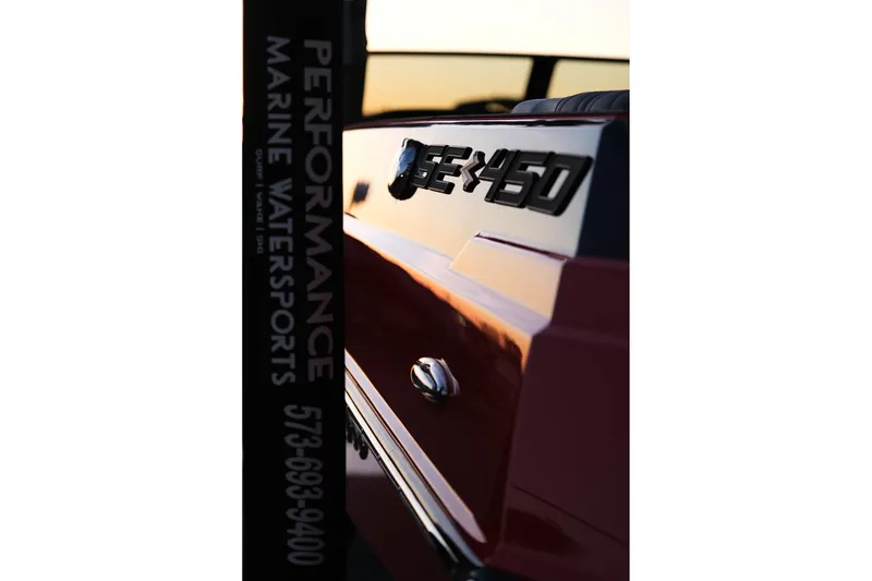 Slide: The Image of 2025 Supra SE boat with SE 450 emblem, sunset reflection. - 32