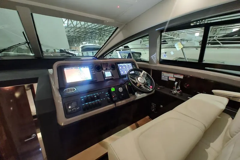 Slide: The Image of 2017 Sea Ray Sundancer 400 helm with modern navigation controls and luxurious seating. - 16