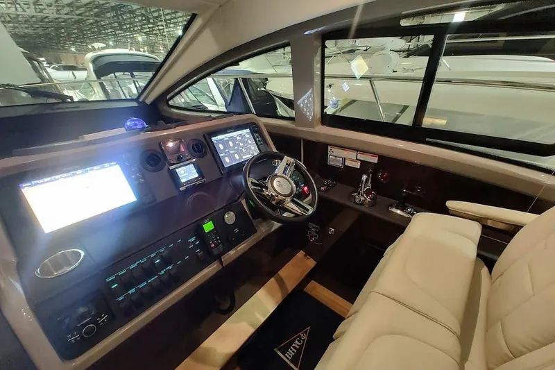 Slide: The Image of 2017 Sea Ray Sundancer 400 helm with modern navigation displays and luxurious seating. - 17