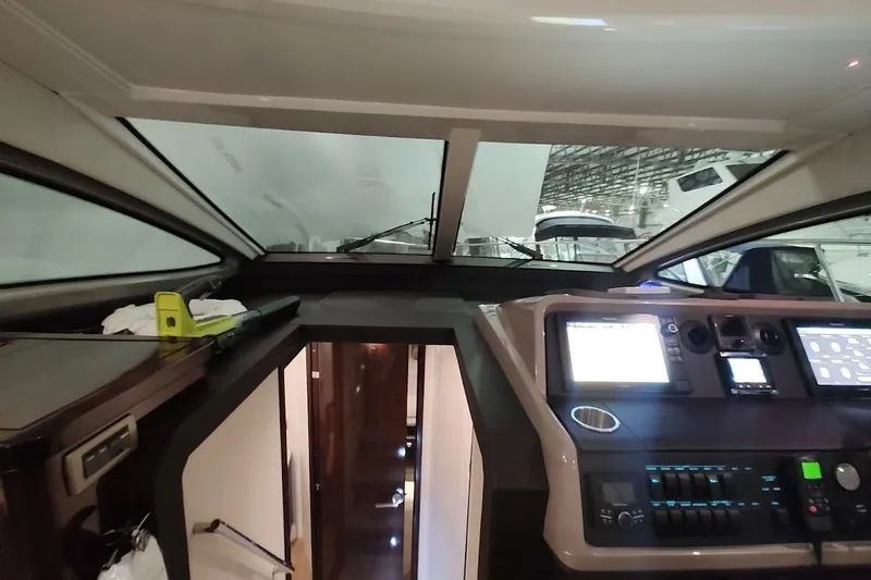 Slide: The Image of Interior view of 2017 Sea Ray Sundancer 400 yacht cockpit with modern controls. - 18
