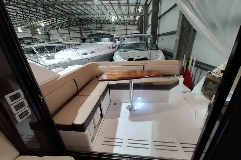 Slide: The Image of 2017 Sea Ray Sundancer 400 yacht interior with seating and table in a marina. - 9