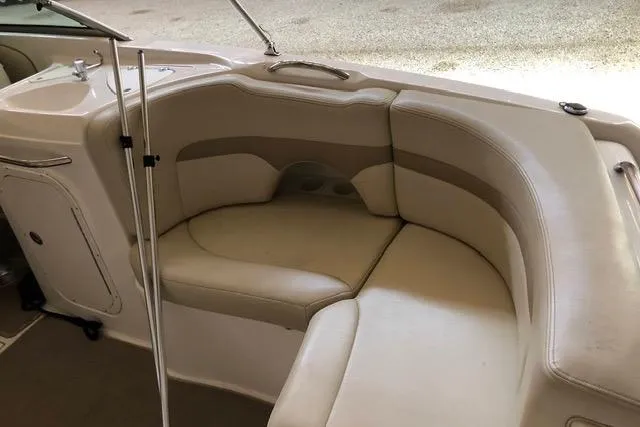 Slide: The Image of 2003 Chaparral Signature 260 boat interior with beige seating and compact kitchenette. - 10