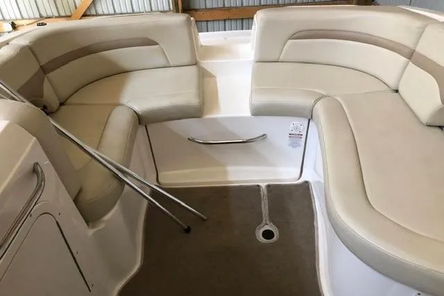 Slide: The Image of 2003 Chaparral Signature 260 boat interior with beige seating and carpeted floor. - 11