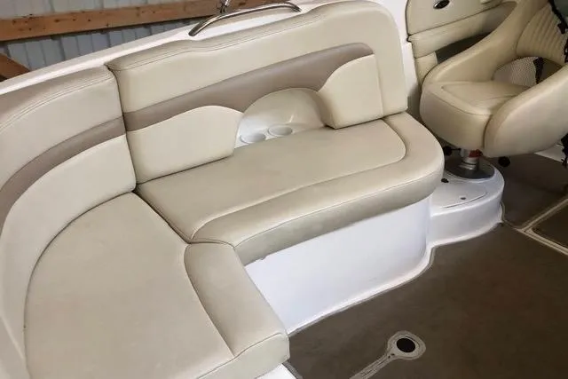 Slide: The Image of 2003 Chaparral Signature 260 boat interior with beige seating and cup holders. - 12