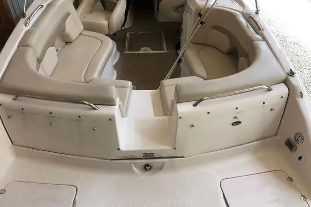 Slide: The Image of 2003 Chaparral Signature 260 boat interior with beige seating and spacious layout. - 13