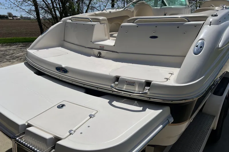 Slide: The Image of 2003 Chaparral Signature 260 boat, rear view, showcasing spacious deck and seating area. - 14