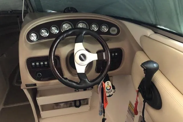 Slide: The Image of 2003 Chaparral Signature 260 boat dashboard with steering wheel and control panel. - 17