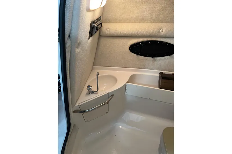 Slide: The Image of 2003 Chaparral Signature 260 boat interior with sink and storage compartment. - 20