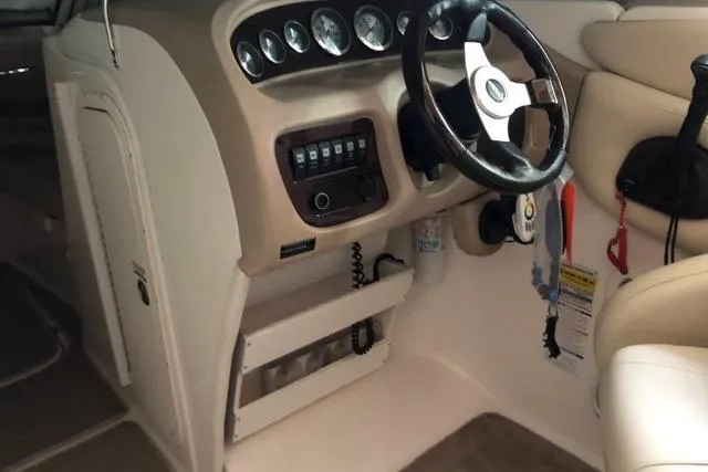 Slide: The Image of 2003 Chaparral Signature 260 boat cockpit with steering wheel and control panel. - 21