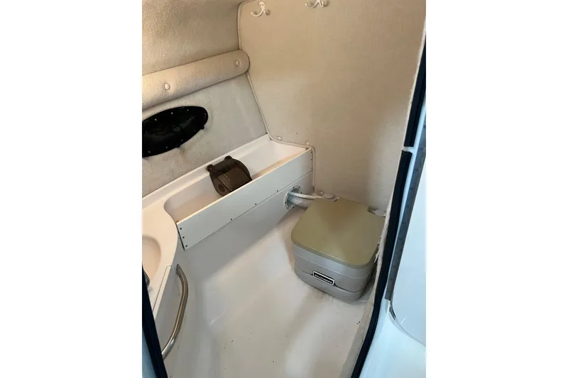 Slide: The Image of 2003 Chaparral Signature 260 boat interior with compact bathroom amenities. - 22