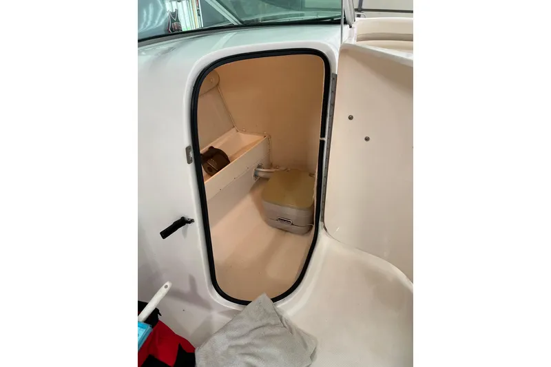 Slide: The Image of 2003 Chaparral Signature 260 boat interior with compact bathroom space. - 23