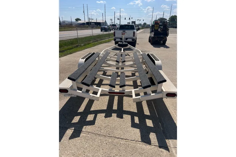 Slide: The Image of Trailer for 2003 Chaparral Signature 260 boat parked on a sunny street. - 24