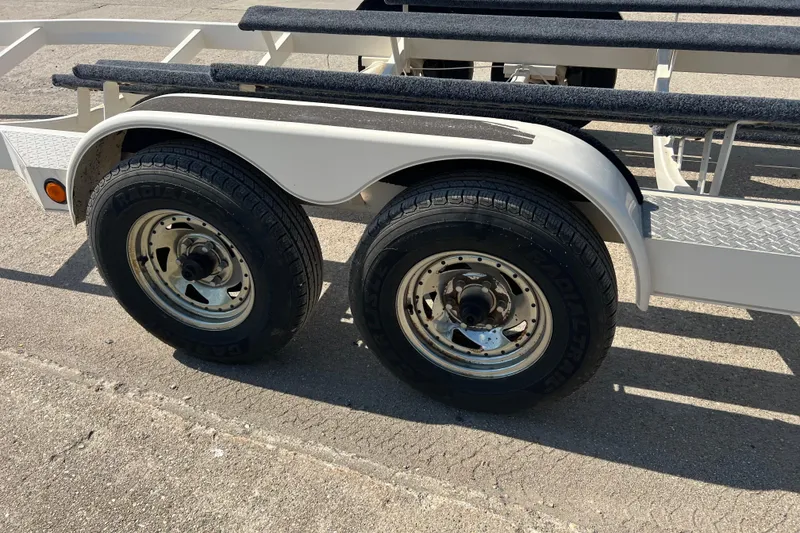 Slide: The Image of Trailer for 2003 Chaparral Signature 260 boat with dual wheels on pavement. - 25