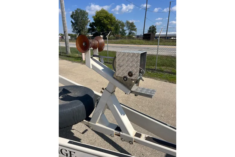 Slide: The Image of Trailer hitch for 2003 Chaparral Signature 260 boat, featuring metal rollers and diamond plate. - 26