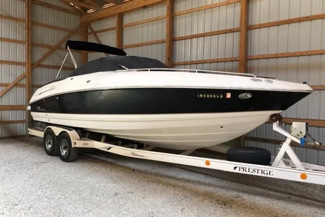 Slide: The Image of 2003 Chaparral Signature 260 boat on trailer in storage shed. - 3
