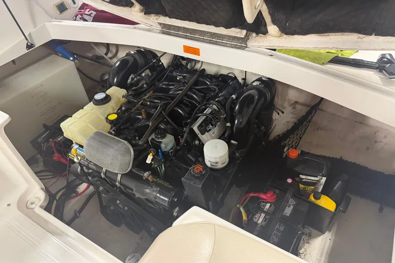 Slide: The Image of Engine compartment of a 2003 Chaparral Signature 260 boat, showcasing detailed components. - 30