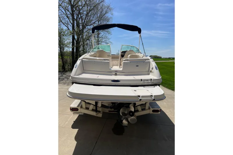 Slide: The Image of 2003 Chaparral Signature 260 boat on trailer, parked outdoors on a sunny day. - 4