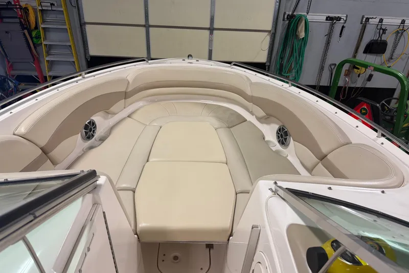 Slide: The Image of 2003 Chaparral Signature 260 boat interior with beige seating and speakers. - 5