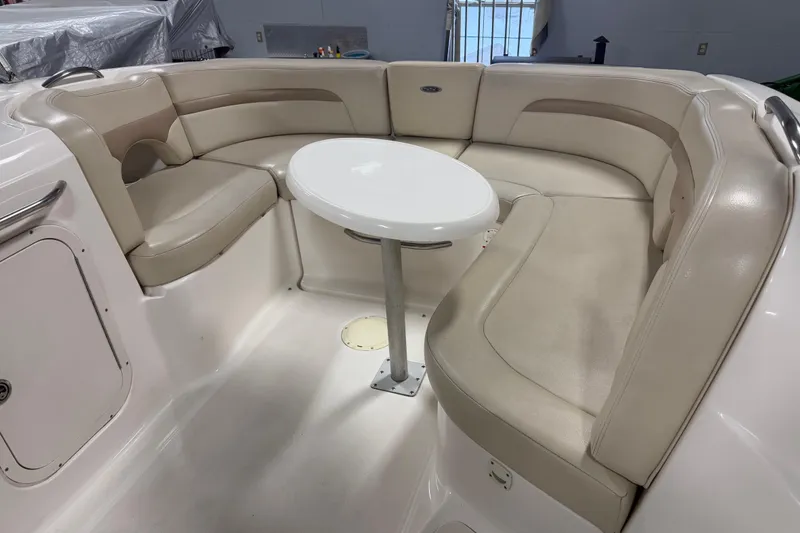Slide: The Image of 2003 Chaparral Signature 260 boat interior with beige seating and a round table. - 7