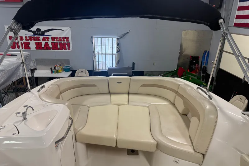 Slide: The Image of 2003 Chaparral Signature 260 boat interior with beige seating and canopy. - 8