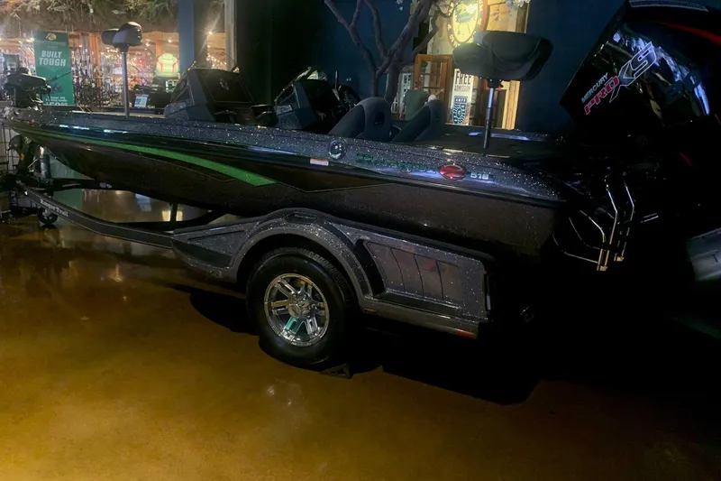 Slide: The Image of 2026 Ranger Z518 boat with sleek design and Mercury Pro XS engine displayed indoors. - 1