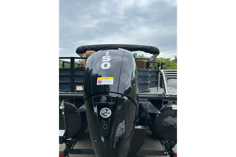 Slide: The Image of 2026 Ranger 223F boat with a powerful 150 HP outboard motor, parked outdoors. - 6