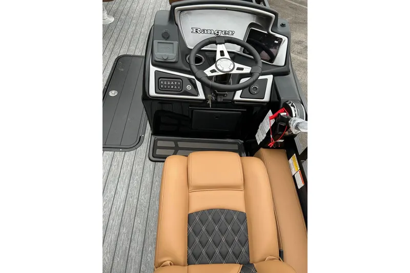 Slide: The Image of 2026 Ranger 223F boat interior with steering wheel and tan seating. - 4