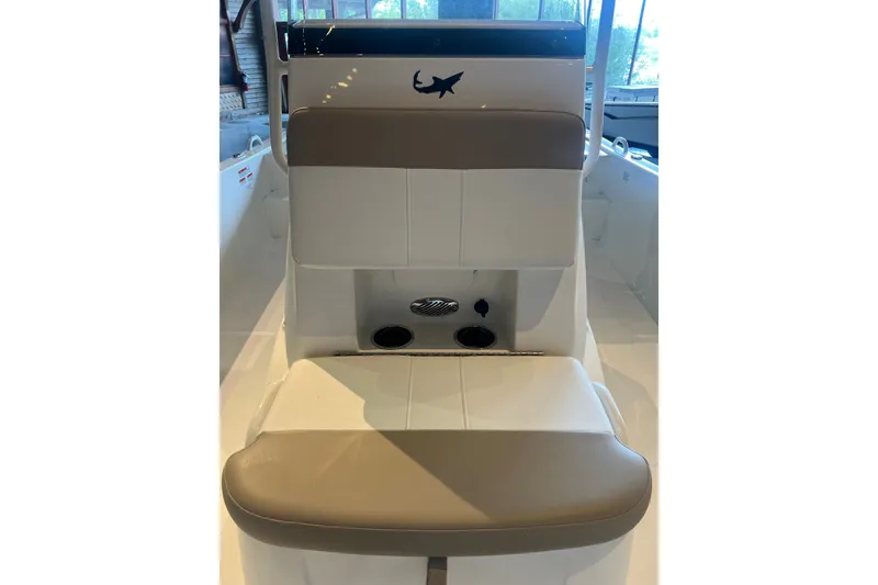 Slide: The Image of 2026 Mako Pro Skiff 19 CC boat interior with cushioned seating and cup holders. - 13