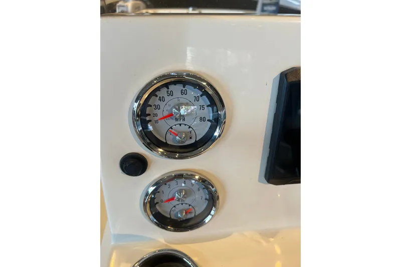 Slide: The Image of Dashboard gauges of 2026 Mako Pro Skiff 19 CC boat, showing speedometer and tachometer. - 7