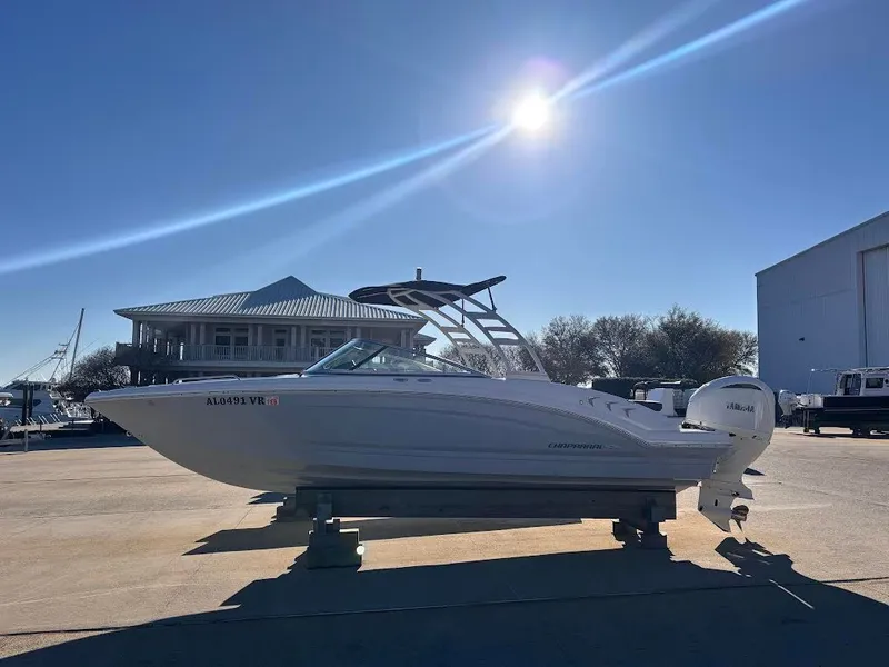 Slide: The Image of 2022 Chaparral 23 SSi OB boat outdoors under bright sun. - 2