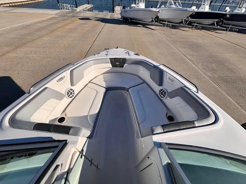 Slide: The Image of Chaparral 23 SSi OB 2022 boat with spacious bow area at dock. - 5