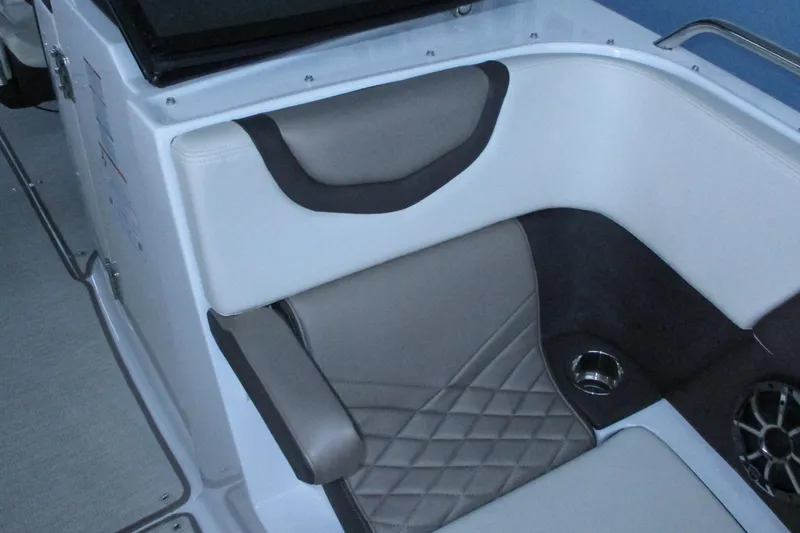Slide: The Image of 2018 Chaparral 287 SSX boat interior with cushioned seating and speaker. - 10