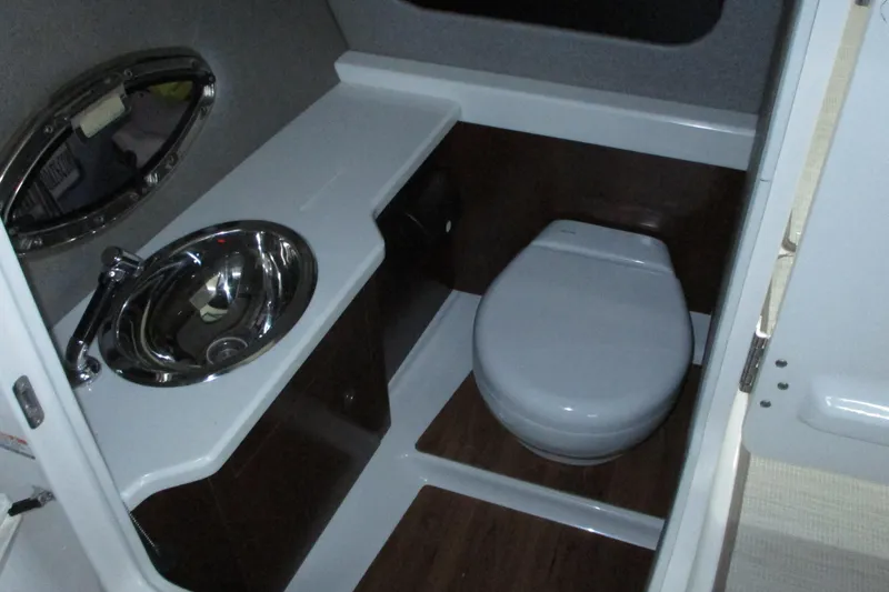 Slide: The Image of 2018 Chaparral 287 SSX boat bathroom with sink and toilet. - 15