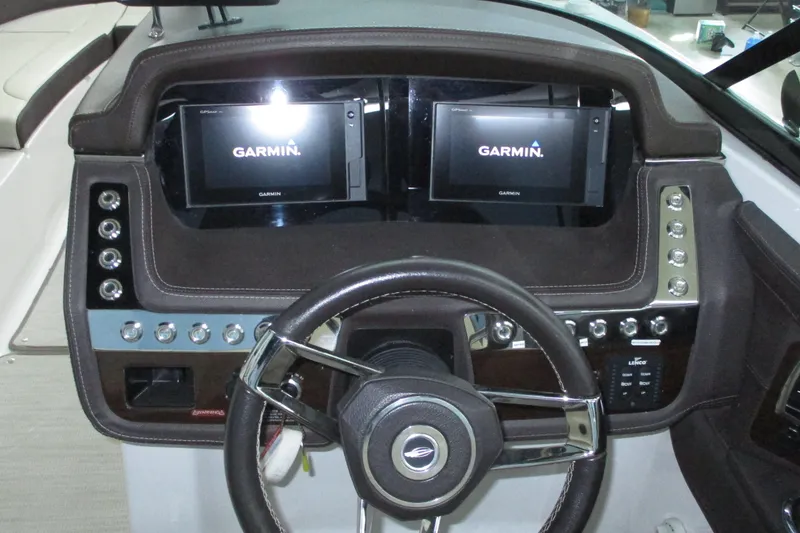 Slide: The Image of 2018 Chaparral 287 SSX dashboard with dual Garmin displays and steering wheel. - 2