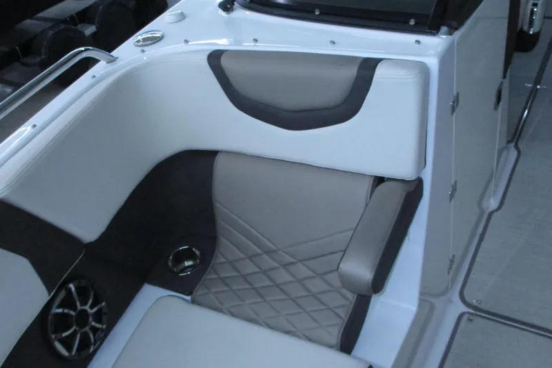 Slide: The Image of 2018 Chaparral 287 SSX boat interior with cushioned seating and speaker. - 9