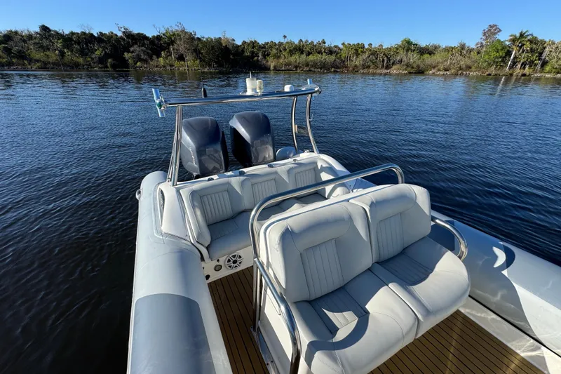 Slide: The Image of 2010 Cobra Ribs Nautique 8.6m boat with dual engines on a calm river. - 12