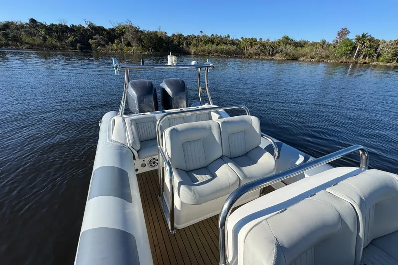Slide: The Image of 2010 Cobra Ribs Nautique 8.6m boat with seating, on calm water. - 13