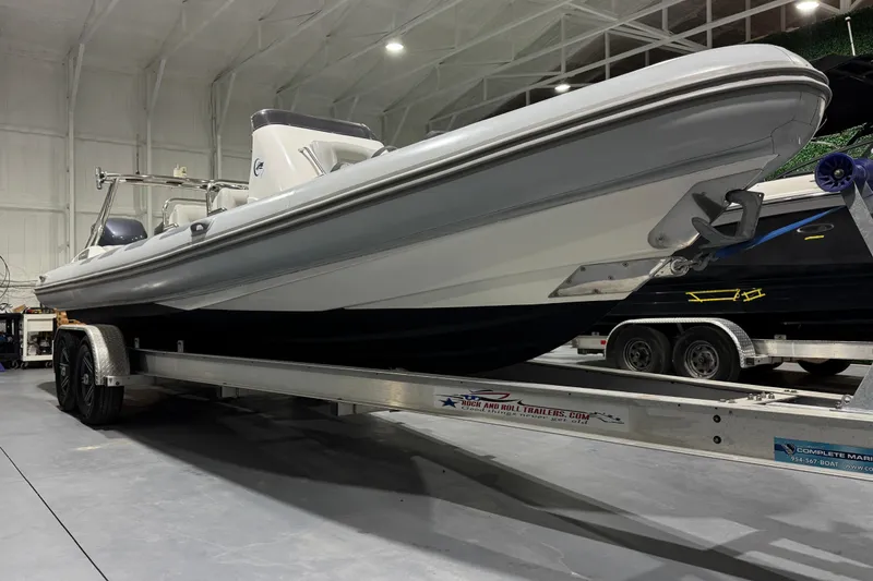 Slide: The Image of 2010 Cobra Ribs Nautique 8.6m boat on trailer in indoor storage facility. - 19