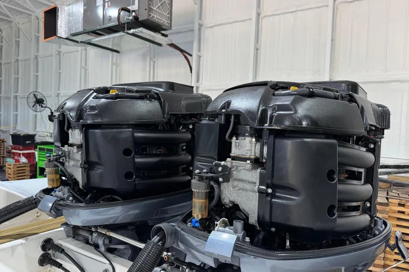 Slide: The Image of Twin engines of a 2010 Cobra Ribs Nautique 8.6m in a workshop setting. - 24