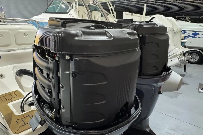 Slide: The Image of Twin outboard engines on a 2010 Cobra Ribs Nautique 8.6m boat in a showroom. - 26