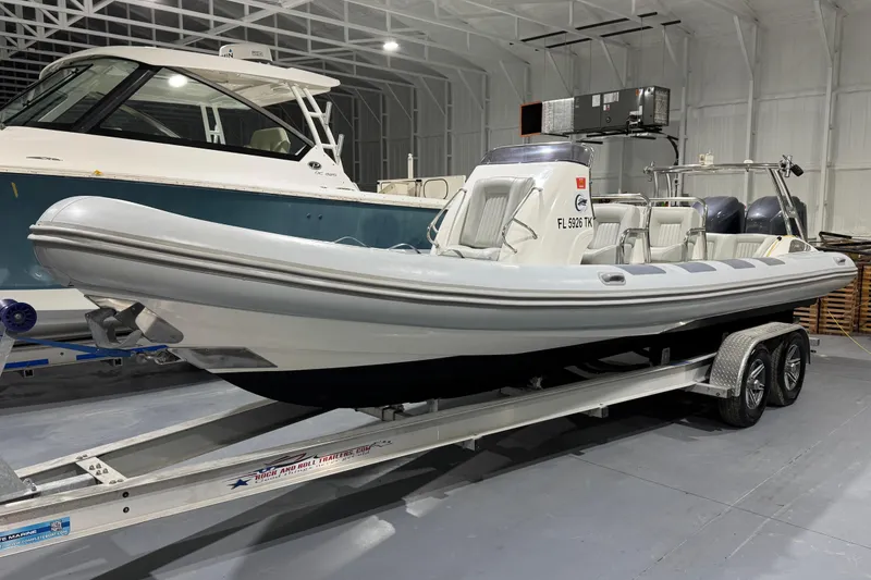 Slide: The Image of 2010 Cobra Ribs Nautique 8.6m boat on trailer in indoor storage facility. - 6